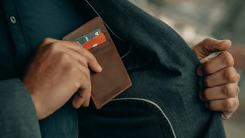man put wallet credit card to pocket Best Credit Cards to Get If You're Starting Rebuild Credit